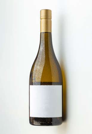 cool white wine bottle with empty label on white backgroundの写真素材