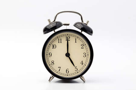 alarm clock shows five o'clockの写真素材