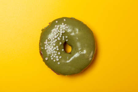 creamy matcha donut on yellow backgroundの写真素材
