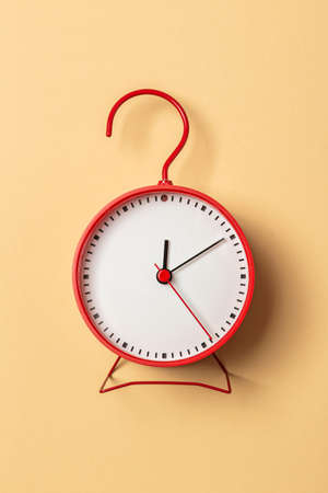 minimalistic red clock on beige backgroundの写真素材