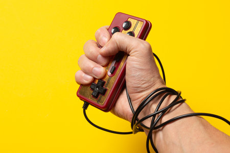 wired hand with joypad, video games addictionの写真素材