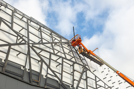 workers install the frame on the facade of the building