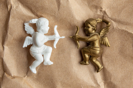 gold and white cupid opposite each otherの写真素材
