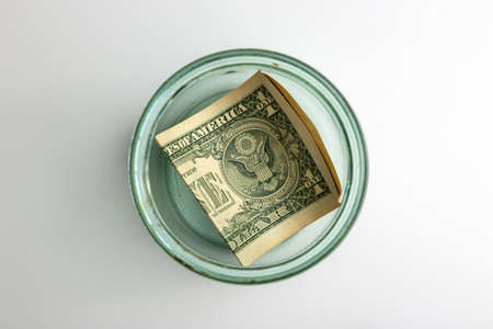 the last dollar at the bottom of a glass jarの写真素材