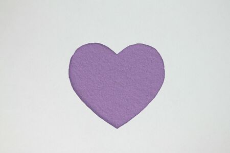 Violet heart shaped slot in craft paper.の写真素材
