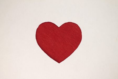 Red heart shaped slot in craft paper.の写真素材