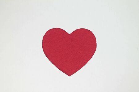 Red heart shaped slot in craft paper.の写真素材
