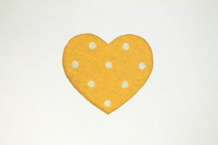 Yellow heart shaped slot in craft paper.の写真素材