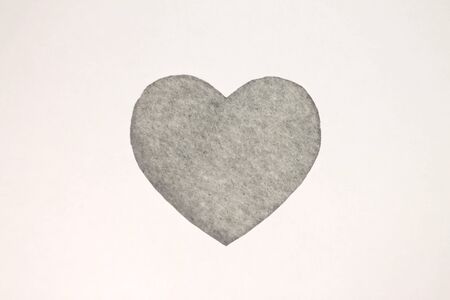Gray heart shaped slot in craft paper.の写真素材