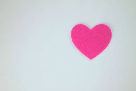 Pink paper heart on a white background. Copy space.の写真素材