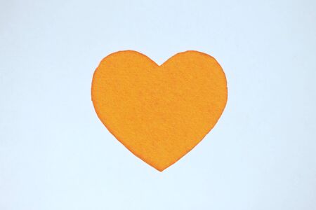 Yellow heart shaped slot in craft paper.の写真素材