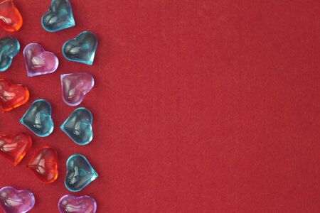 Glass hearts on a red background. Valentines day. Place for text.の写真素材