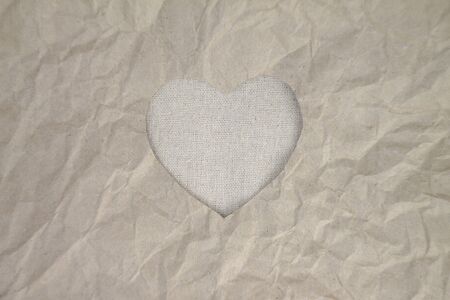 Gray heart shaped slot in craft paper.の写真素材