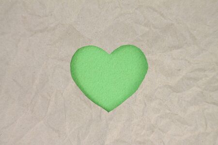 Green heart shaped slot in craft paper.の写真素材