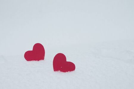 Two red hearts in the snow. Valentines Day.の写真素材