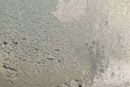 Blue window glass covered hoarfrost ice pattern texture with water drops. Cold nature winter background.の写真素材