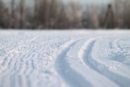 Ski track in snow. Hilly snowy surface. Active winter holiday concept. Stock photo for web and...