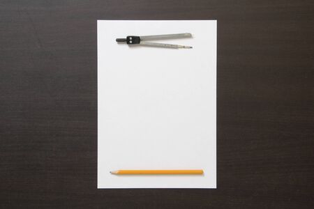 Template of white paper, divider and pencil on dark wenge color wooden background. Concept of new idea, business plan and strategy. Stock photo with empty space for text and designの写真素材