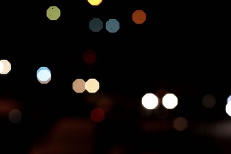 Light spots round multi-colored in the night on a dark background glow, shine. Garland.