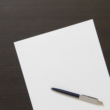 Template of white paper with pen on dark wenge color wooden background. Concept of business plan and...
