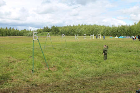 6 july 2019 Syktyvkar, Komi, Russia. Barcamps annual event. An informal summer conference with lectures and speeches by public figures and experts. View of a field with green grass and a campground.のeditorial素材