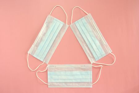 Medical disposable mask on a pink background. Coronovirus Outbreak Defense Concept.の写真素材