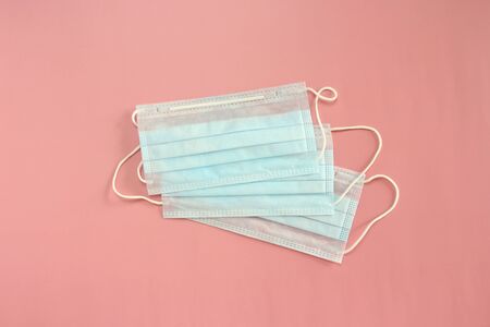 Medical disposable mask on a pink background. Coronovirus Outbreak Defense Concept.の写真素材