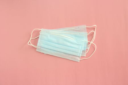 Medical disposable mask on a pink background. Coronovirus Outbreak Defense Concept.の写真素材