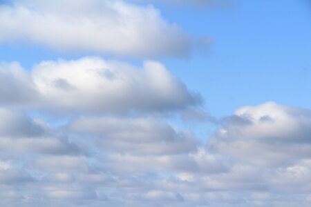 Lovely white fluffy clouds on a background of blue sky.の写真素材