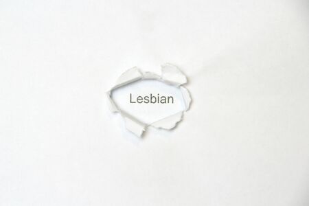 Word lesbian on white isolated background, the inscription through wound hole in the paper. Concept of gender identity and sexual minorities. Stock photo for web and print with empty space for textの写真素材