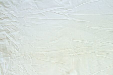 Crumpled white linen fabric cotton for wallpaper design. Brown weave cotton background texture.の写真素材