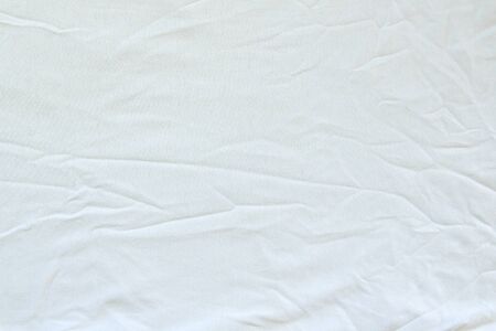 Crumpled white linen fabric cotton for wallpaper design. Brown weave cotton background texture.の写真素材