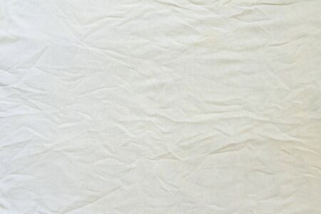 Crumpled white linen fabric cotton for wallpaper design. Brown weave cotton background texture.の写真素材