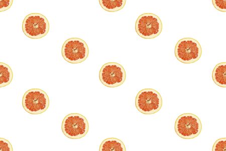 Seamless pattern of isolated slices of grapefruit. Wallpaper for background, design and packaging.の写真素材