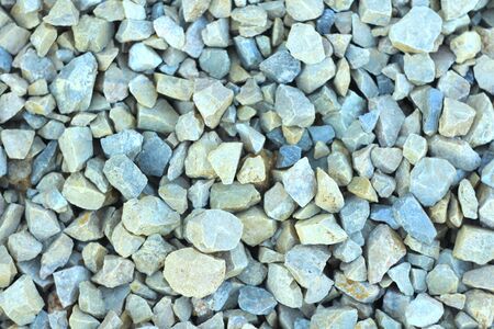 Background of blue and gray gravel. Small stones lie on the ground at a construction site. Pebble pattern on the beach.の写真素材