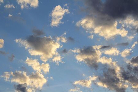 Cloudy blue sky with white and gray clouds. Background for text and design.の写真素材