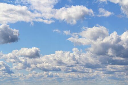 White fluffy clouds on a background of blue sky in summer. The concept of weather and climate.の写真素材