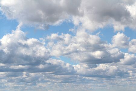White fluffy clouds on a background of blue sky in summer. The concept of weather and climate.の写真素材