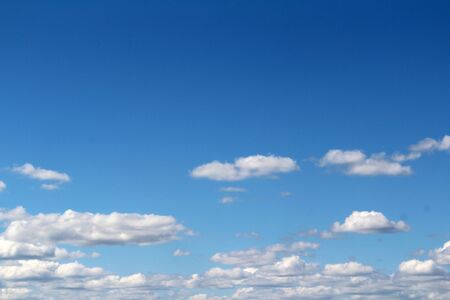 White fluffy clouds on a background of blue sky in summer. The concept of weather and climate.の写真素材