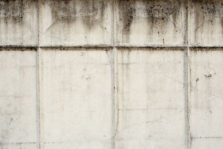 Grey old concrete wall with cracks and rectangular relief pattern. Concrete texture, space for text and layout for design.の写真素材