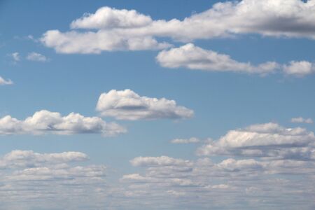 White fluffy clouds on a background of blue sky in summer. The concept of weather and climate.の写真素材
