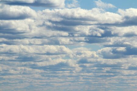 White fluffy clouds on a background of blue sky in summer. The concept of weather and climate.の写真素材