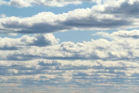 White fluffy clouds on a background of blue sky in summer. The concept of weather and climate.の写真素材