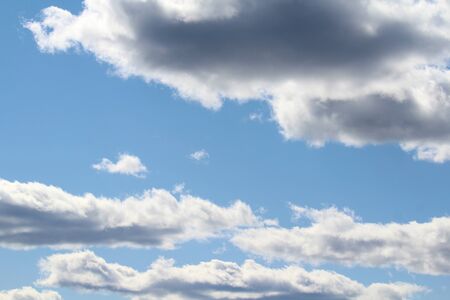 White fluffy clouds on a background of blue sky in summer. The concept of weather and climate.の写真素材