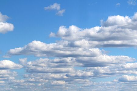 White fluffy clouds on a background of blue sky in summer. The concept of weather and climate.の写真素材