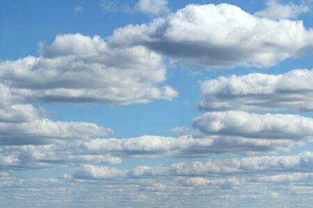 White fluffy clouds on a background of blue sky in summer. The concept of weather and climate.の写真素材
