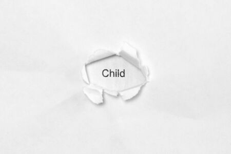Word Child on white isolated background, the inscription through the wound hole in paper. Concept of gender identity and sexual minorities. Stock photo for web and print with empty space for textの写真素材