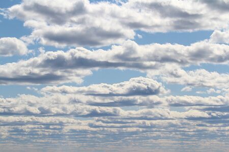 White fluffy clouds on a background of blue sky in summer. The concept of weather and climate.の写真素材