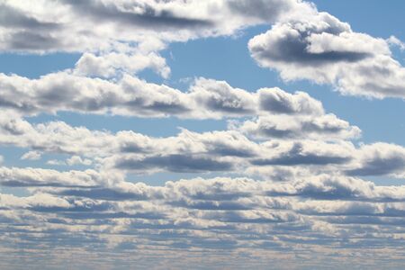 White fluffy clouds on a background of blue sky in summer. The concept of weather and climate.の写真素材