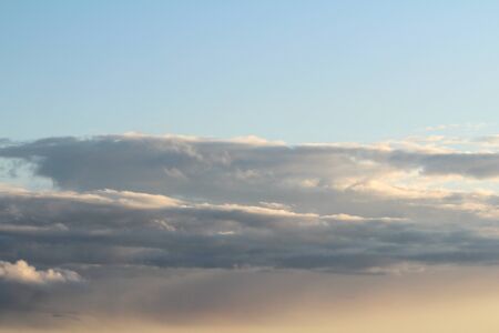 White fluffy clouds on a background of blue sky in summer. The concept of weather and climate.の写真素材